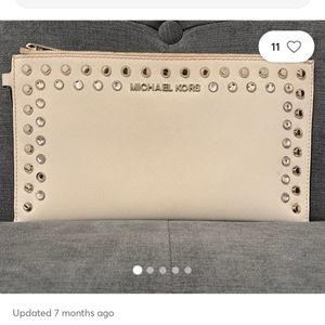 MICHAEL KORS CLUTCH IVORY STUDS AND GEMS ON FRONT ITS SLIGHTLY USED